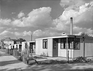 <b class=qtipBold><figcaption>Prefabs P_H00049_005</figcaption></b><br>Uni-Seco prefabricated houses, Lyham Road, Brixton, London. 22nd September 1945. Ministry of Works. Prefabricated houses were constructed in Lyham Road and other similar sites in the area, in spaces left between older houses, where buildings had been destroyed by bombing.<br><em>© Historic England Archive</em> Prefabs P_H00049_005