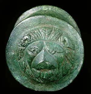 <b class=qtipBold><figcaption>Roman hub cap K870175</figcaption></b><br>LULLINGSTONE ROMAN VILLA, Kent. Bronze wheel hub-cap, decorated with head of lion, found in Room 8.<br><em>© Historic England</em> Roman hub cap K870175