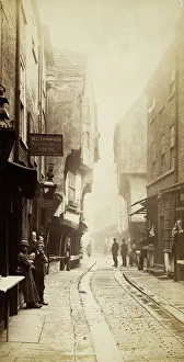<b class=qtipBold><figcaption>Shambles OP16536</figcaption></b><br>Shambles, York. The pub sign for the Shoulder of Mutton Inn, landlord M C Thompson, is hanging in the foreground. Photographed probably 1890s.<br><em>© Historic England Archive</em> Shambles OP16536