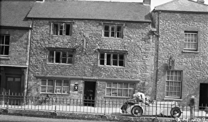 <b class=qtipBold><figcaption>Sherborne in 1939 BB056814</figcaption></b><br>Plume Of Feathers Hotel, Half Moon Street, Sherborne, Dorset. A gentleman is sitting in a sports car with a large bundle in the passenger seat. Photographed in May 1939.<br><em>© Historic England Archive</em> Sherborne in 1939 BB056814