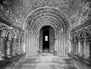 <b class=qtipBold><figcaption>Southwell Minster CC96_00049</figcaption></b><br>SOUTHWELL MINSTER, Nottinghamshire. The interior of the Norman north porch looking toward the elaborate zig-zag five order doorway with a tunnel vaulted roof. The minster was founded before the Conquest in the 950s, and afterwards became one the major churches of the region. Photographed by Henry Taunt (active 1860-1922).<br><em>© Historic England</em> Southwell Minster CC96_00049