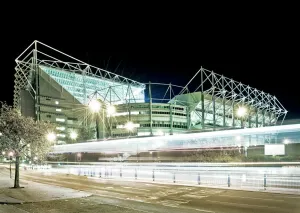 Prints of ST JAMES PARK, Newcastle-upon-Tyne. Home of Newcastle United Football Club. The stark lighting helps the stadium to stand out on the Newcastle skyline. Played on Tyne and Wear Northern Ireland Prints: Print of St. James Park, a football stadium in Newcastle-upon-Tyne