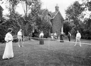 Prints of Tennis Match, Buckinghamshire. A group playing a doubles match in lawn tennis. Date range: 1896 - 1920. Alfred Newton and Son Buckinghamshire Prints: Lawn Tennis Print, Buckinghamshire, 1896-1920