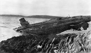 <b class=qtipBold><figcaption>Stranded submarine JXC01_01_008</figcaption></b><br>Near Falmouth, Cornwall. The wreck of the submarine UB 106 on the rocks. Five German U-boats were moored at Falmouth after being surrended to the Royal Navy in 1918. After several were stranded in 1921 the submarines were broken up in situ. Photographed by Captain Jack Casement in 1921.<br><em>© Historic England Archive</em> Stranded submarine JXC01_01_008