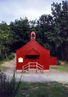 <b class=qtipBold><figcaption>Tin Tabernacle FF98_00205</figcaption></b><br>St Chad's Mission Church, Blists Hill, Madeley, Shropshire. Exterior view showing the entrance. Originally built at Lodge Bank, Muxton in 1888, to serve colliery workers. This corrugated iron church was moved here in 1977 as an open air museum exhibit. Photographed by Eric de Mare, 1978-1980.<br><em>© Historic England Archive</em> Tin Tabernacle FF98_00205