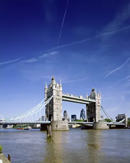 <b class=qtipBold><figcaption>Tower Bridge J060038</figcaption></b><br>TOWER BRIDGE, London. Tower Bridge and the river Thames. Vapour trails in the sky with "Gherkin" Swiss Re Tower framed by bridge.<br><em>© Historic England</em> Tower Bridge J060038
