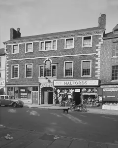 Prints of Exterior view showing the front elevation of 60 Scotch Street, Carlisle, Cumberland. Formerly the Blue Bell Coaching Inn, showing the right side occupied by Halfords motor and cycle stores. 1950 Cumberland Prints: Halfords Carlisle Print, 1950 Exterior View
