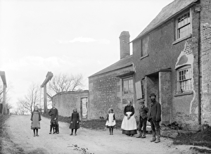 <b class=qtipBold><figcaption>Uffington, Oxfordshire BB97_11909</figcaption></b><br>Uffington, Oxfordshire. A family group standing outside their cottage. In the background is the frame for a lifting canal bridge. The canal, which ran from Semington to Abingdon, was in use from 1810 until 1914. canal bridge. Photographed by Frederick Ault in 1916. Part of the Henry Taunt collection.<br><em>© Historic England</em> Uffington, Oxfordshire BB97_11909