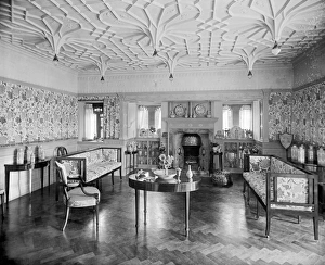 <b class=qtipBold><figcaption>Victorian drawing room BL12849B</figcaption></b><br>Bidston Court, Birkenhead. Victorian interior of the drawing room looking towards the windows and fireplace. Bidston Court was built in 1891 by the Liverpool architects Grayson & Ould. The drawing room is formally decorated, with Gothic windows, Tudor platerwork, Morris wallpaper and fabrics and Georgian-style furniture. The house was demolished in 1931 and rebuilt as 'Hillbark' in Roydon Park, Wirral, Merseyside. Photographed in July 1894 by H Bedford Lemere.<br><em>© Historic England</em> Victorian drawing room BL12849B