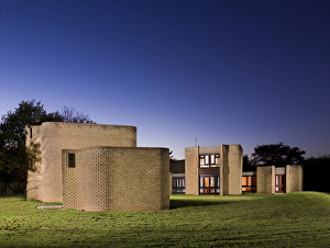 <b class=qtipBold><figcaption>Warwick University DP147511</figcaption></b><br>Houses for Visiting Mathematicians, Gibbet Hill Campus, Warwick University. Housing lit at twilight. Designed in 1967, built 1968-9 by Howell, Killick, Partridge and Amis.<br><em>© Historic England</em> Warwick University DP147511