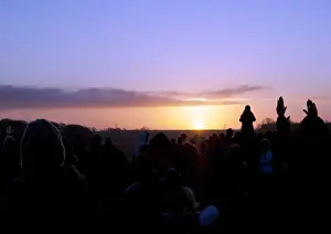 Prints of Stonehenge, Stonehenge Down, Amesbury, Wiltshire. Crowds watching the sunrise at Stonehenge on the winter solstice, from the west Amesbury Prints: Winter Solstice Print at Stonehenge