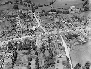<b class=qtipBold><figcaption>Wootton Bassett, 1930. EPW032626</figcaption></b><br>WOOTTON BASSETT, Wiltshire. Aerial view of the Church of St. Bartholomew and All Saints, Wood Street, High Street and Station Road, June 1930. Aerofilms Collection (see Links).<br><em>© Historic England</em> Wootton Bassett, 1930. EPW032626