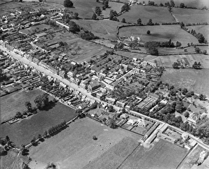 <b class=qtipBold><figcaption>Wootton Bassett, 1930. EPW032629</figcaption></b><br>WOOTTON BASSETT, Wiltshire. Aerial view of the Wesleyan Methodist Chapel, Coxstalls and the High Street, June 1930. Aerofilms Collection (see Links).<br><em>© Historic England</em> Wootton Bassett, 1930. EPW032629
