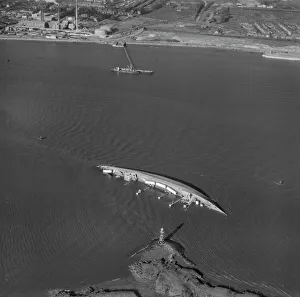 <b class=qtipBold><figcaption>Wreck at Fidlers Reach EAW143996</figcaption></b><br>River Thames, London November 1964. The capsized German Cargo Vessel "Magdeburg" laden with buses bound for Cuba. A collision with the "Yamashiro Maru" caused the wreck. Aerofilms Collection.<br><em>© Historic England</em> Wreck at Fidlers Reach EAW143996