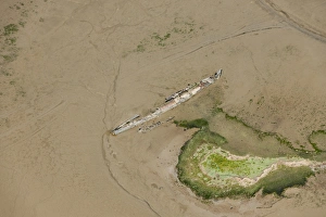 <b class=qtipBold><figcaption>Wrecks at Stoke Saltings 29652_042</figcaption></b><br>Remains of a First World War U-Boat (UB122) and the sailing boat Swale embedded in mud flats. Stoke Saltings, River Medway. Photographed 27th May 2015.<br><em>© Historic England Archive</em> Wrecks at Stoke Saltings 29652_042