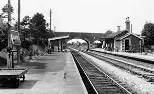<b class=qtipBold><figcaption>Dauntsey Station, 1961</figcaption></b><br>A serene view of Dauntsey Station taken in August 1961. The photograph captures the main station building on the Up platform and the waiting room opposite, as well as the small signal box sited beyond the foot and road bridges. For a small station Dauntsey had unusually long platforms which had been extended since the station's original construction in order to accommodate the longer main line trains that passed through. Dauntsey Station, 1961