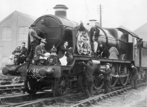 Prints of Castle Class locomotive, Windsor Castle, is being prepared with royal regalia at Swindon Works. Eight men can be seen cleaning the locomotive ready for use by the Royal Family Locomotive Prints: Print of Locomotive No 4082, Windsor Castle, c. 1920s