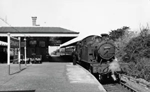 <b class=qtipBold><figcaption>Perranporth Station, April 1960</figcaption></b><br>Locomotive No 4593 stands at Perranporth Station on 23rd April 1960 while the driver chats to a member of station staff before continuing on its journey to Newquay. The island platform sits between two running lines on the Truro to Newquay railway. A glimpse of a train waiting on the opposite platform can be seen to the left of the photograph. Perranporth Station, April 1960
