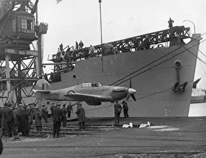 A Sea Hurricane being loaded onto an armed merchant ship at Cardiff docks, c.1941 A Sea Hurricane being loaded onto an armed merchant ship at Cardiff docks, c.1941