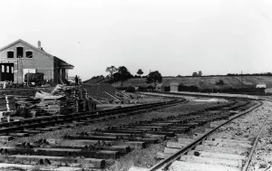 Prints of A view of Broadway Goods Yard in Worcestershire taken in c.1904 whilst it was under construction, showing building materials stacked up alongside the tracks Stations And Halt Prints: Print of Broadway Goods Yard Under Construction, c. 1904
