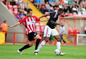 Bristol Citys Marvin Elliott battles for the ball with Ryan Harley Bristol Citys Marvin Elliott battles for the ball with Ryan Harley