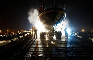 Hoylake mersey class lifeboat Lady of Hilbre 12-005 being washed down by shore crew on the slipway at night Hoylake mersey class lifeboat Lady of Hilbre 12-005 being washed down by shore crew on the slipway at night