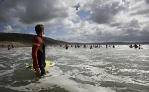 Images Dated 12th November 2009: An RNLI lifeguard in the sea at Woolacombe beach, Devon.Lots of people in the water swimming