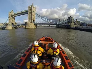 Images Dated 27th August 2013: Tower E-class lifeboat Hurley Burly E-07 heading along the Thames towards Tower Bridge