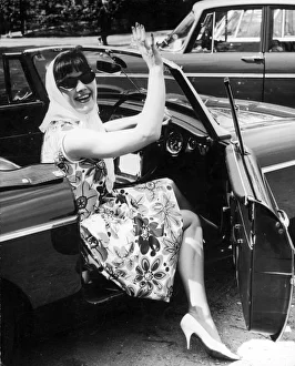 <b class=qtipBold><figcaption>60S Fashion/Convertible</figcaption></b><br>A girl in a flower print dress, white high heels, a headscarf and sunglasses steps out of a convertible car.<br><em>© Mary Evans Picture Library</em> 60S Fashion/Convertible