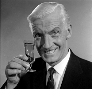 <b class=qtipBold><figcaption>Advertisement for Emu sherry</figcaption></b><br>Advertisement for Emu sherry -- smiling male model (George McGrath) holding up a glass. 1959<br><em>© The Colin Sherborne Collection/Mary Evans Picture Library</em> Advertisement for Emu sherry