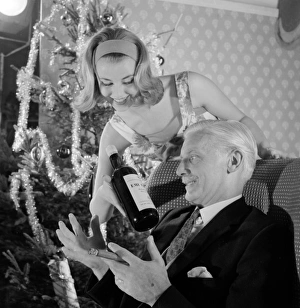 <b class=qtipBold><figcaption>Advertisement for Emu sherry</figcaption></b><br>Advertisement for Emu sherry -- male and female models posing in Christmas party scene. 1959<br><em>© The Colin Sherborne Collection/Mary Evans Picture Library</em> Advertisement for Emu sherry