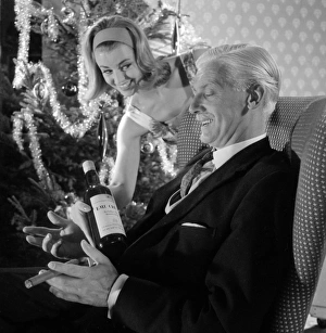 <b class=qtipBold><figcaption>Advertisement for Emu sherry</figcaption></b><br>Advertisement for Emu sherry -- male and female models posing in Christmas party scene. 1959<br><em>© The Colin Sherborne Collection/Mary Evans Picture Library</em> Advertisement for Emu sherry