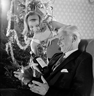 <b class=qtipBold><figcaption>Advertisement for Emu sherry</figcaption></b><br>Advertisement for Emu sherry -- male and female models posing in Christmas party scene. 1959<br><em>© The Colin Sherborne Collection/Mary Evans Picture Library</em> Advertisement for Emu sherry