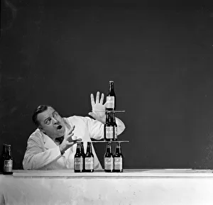 <b class=qtipBold><figcaption>Advertisement for Manns brown ale</figcaption></b><br>Advertisement for Manns brown ale -- male model constructing a pyramid of bottles. 1959<br><em>© The Colin Sherborne Collection/Mary Evans Picture Library</em> Advertisement for Manns brown ale