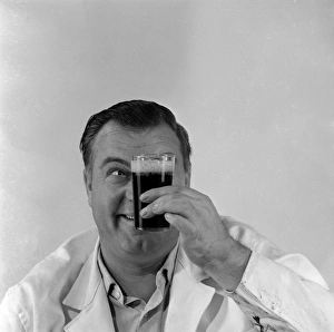 <b class=qtipBold><figcaption>Advertisement for Manns brown ale</figcaption></b><br>Advertisement for Manns brown ale -- male model holding up a full glass. 1959<br><em>© The Colin Sherborne Collection/Mary Evans Picture Library</em> Advertisement for Manns brown ale