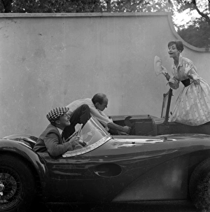 <b class=qtipBold><figcaption>Advertisement for Manns brown ale</figcaption></b><br>Advertisement for Manns brown ale -- male and female models posing with a car that won't start. 1959<br><em>© The Colin Sherborne Collection/Mary Evans Picture Library</em> Advertisement for Manns brown ale