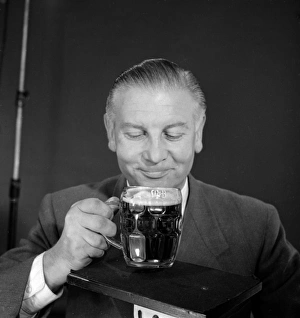 <b class=qtipBold><figcaption>Advertisement for M&B Mild Beer</figcaption></b><br>Advertisement for M&B Mild Beer -- male model (Vincent Charles) posing with a pint glass. 1959<br><em>© The Colin Sherborne Collection/Mary Evans Picture Library</em> Advertisement for M&B Mild Beer