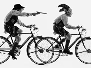 <b class=qtipBold><figcaption>Advertisement for Triumph bicycles</figcaption></b><br>Advertisement for Triumph bicycles -- two boy models playing Cowboys and Indians. 1959<br><em>© The Colin Sherborne Collection/Mary Evans Picture Library</em> Advertisement for Triumph bicycles