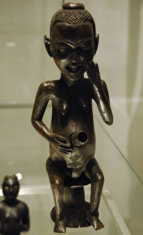Africa. Pipe in the form of a seated female figure. Made of Africa. Pipe in the form of a seated female figure. Made of
