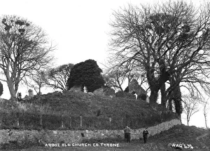 Prints of Arboe Old Church, Co Tyrone - a low view of a derelict church with two men for scale. (Location: Northern Ireland: County Tyrone: Ardboe). Date: circa early 1900s County Tyrone Prints: Arboe Old Church Print, Northern Ireland circa early 1900s