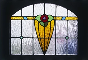 <b class=qtipBold><figcaption>Art Deco Stained Glass</figcaption></b><br>A typically colourful leaded stained glass window with a simple Art Deco design, actually in the front door of 17 Braemar Gardens, West Wickham, 'The 1940s House'.<br><em>© Mary Evans Picture Library/SIMON ROBERTS</em> Art Deco Stained Glass