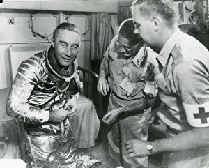 Astronaut Virgil ?Gus? Grissom starts to remove his spa? Astronaut Virgil ?Gus? Grissom starts to remove his spa?
