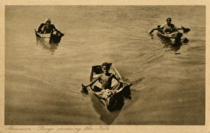 Aswan, Egypt - Three boys crossing the Nile in small boats Aswan, Egypt - Three boys crossing the Nile in small boats