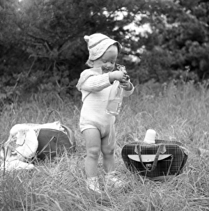 <b class=qtipBold><figcaption>Baby girl at a picnic</figcaption></b><br>A little girl has found the picnic basket. 1955. Date: 1955<br><em>© Landskrona Museum / IBL / Mary Evans</em> Baby girl at a picnic