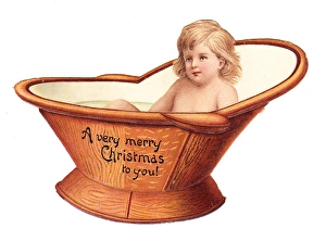 Baby in a hip bath on a cutout Christmas card Baby in a hip bath on a cutout Christmas card