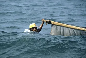Bali fisherman up to his neck in water Bali fisherman up to his neck in water