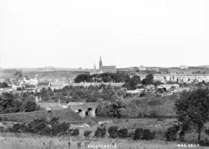 Prints of Ballycastle - an elevated view of the town and railway station. There is a Church and bridge in the picture. (Location: Northern Ireland; County Antrim; Ballycastle). Date: circa early 1900s Railway Prints: Early 20th Century Print of Ballycastle, Northern Ireland