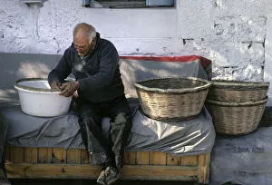 Basket maker, at work outside his house in Thassos, Greece Basket maker, at work outside his house in Thassos, Greece