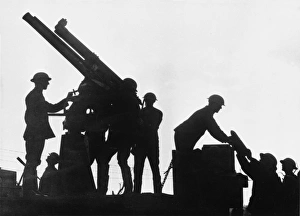 <b class=qtipBold><figcaption>Battle of Broodseinde</figcaption></b><br>Silhouette of an anti aircraft gun (13 pounder 9 cwt) mounted on a motor lorry being fired by soldiers at the Battle of Broodseinde on 4th October 1917 during World War I<br><em>© Mary Evans/Robert Hunt Collection</em> Battle of Broodseinde