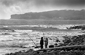 Two beach fishermen with their rods and line Two beach fishermen with their rods and line